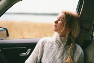 a woman staring out the window of a car