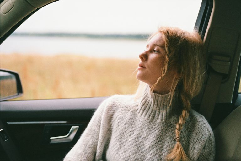 a woman staring out the window of a car