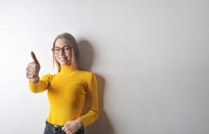 a woman smiling in a yellow top