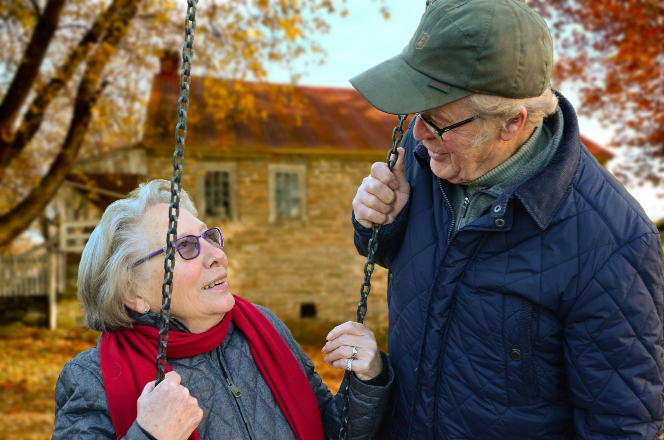 a man and woman sitting in a park